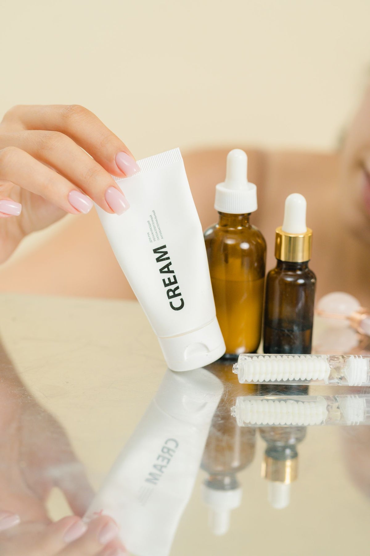 Skincare containers arranged on a reflective surface